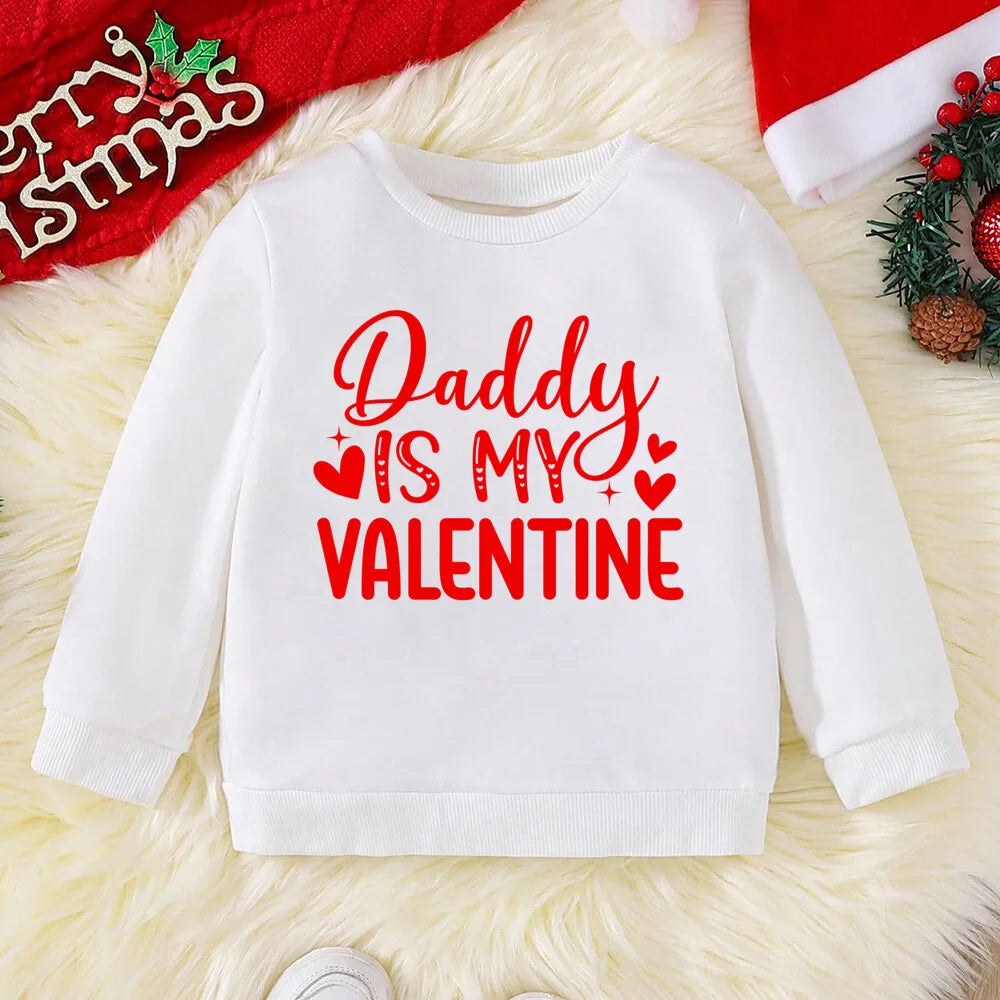 White sweatshirt with 'Daddy is my Valentine' text on a festive background