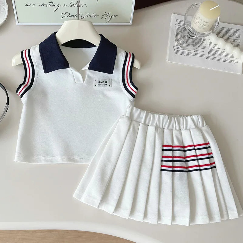White sleeveless top and pleated skirt with red and black stripes on a light surface.