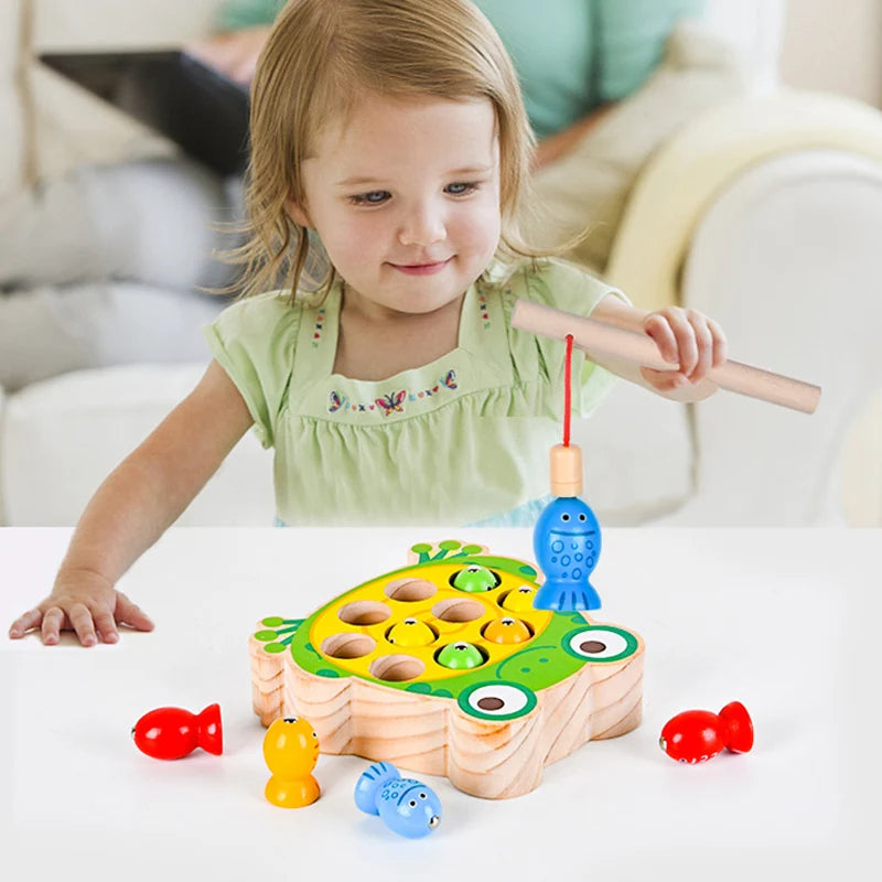 Child playing with a colorful wooden fishing game toy indoors.