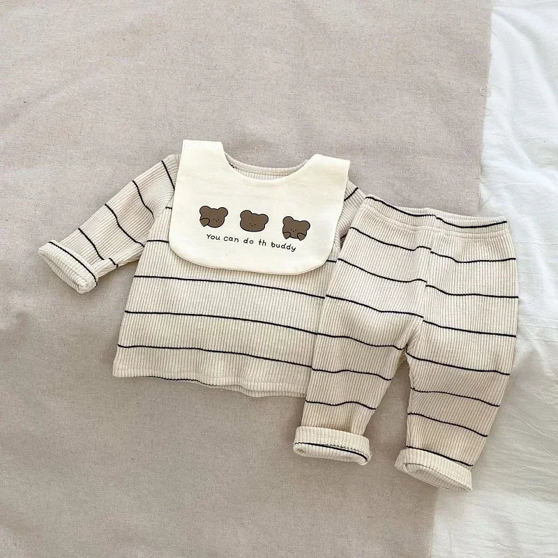 Baby outfit with striped shirt, bib, and pants on a neutral background