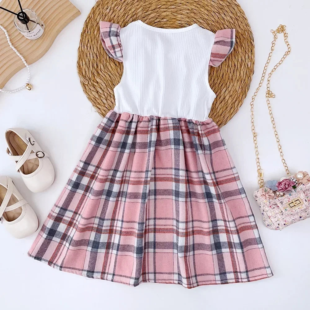 White top with pink plaid skirt on a white background
