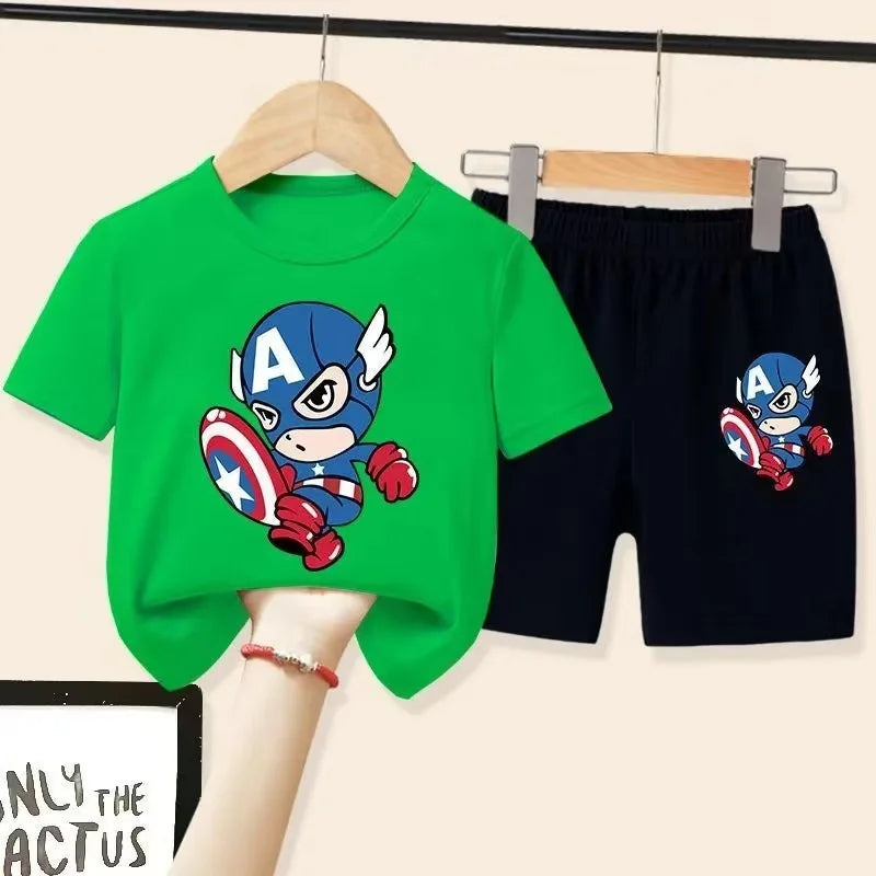 Green t-shirt with Captain America design and black shorts on hangers against a beige background.