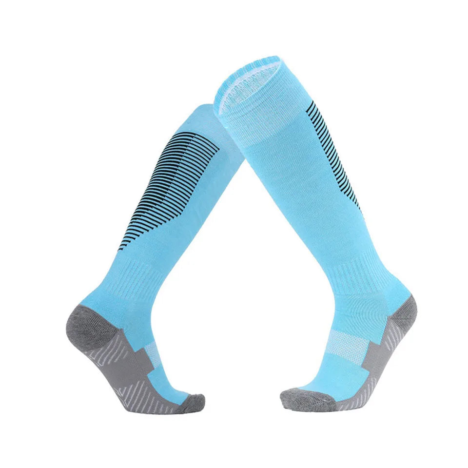 Pair of light blue knee-high socks with gray toes and heels on a white background