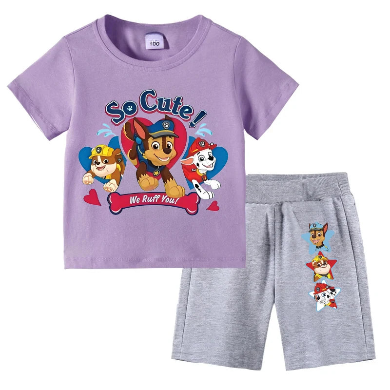 Children's outfit with purple t-shirt and gray shorts featuring cartoon characters on a white background.