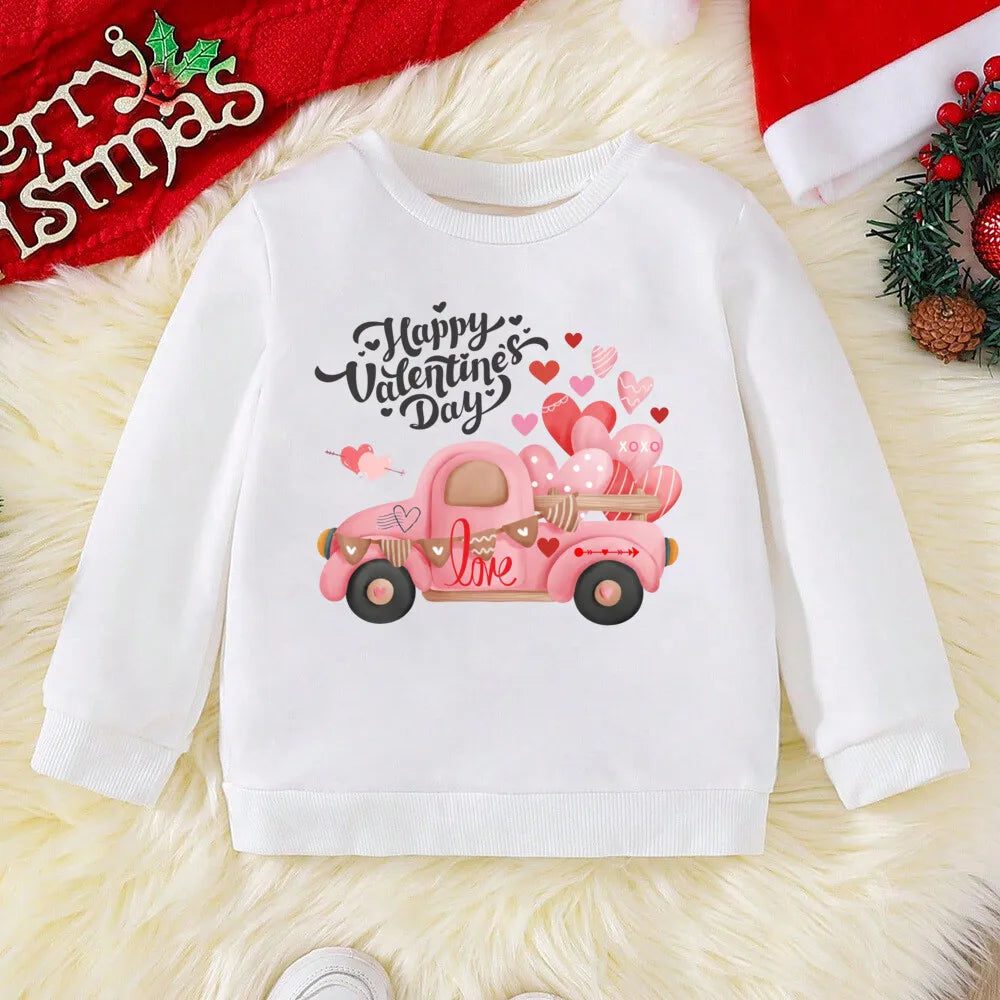 White sweatshirt with Valentine's Day design featuring a pink truck and hearts on a textured surface.