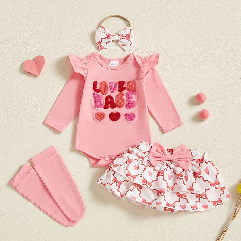 Baby outfit set with pink romper, skirt, headband, and leg warmers on a beige background.