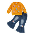 Children's outfit with orange sweater and blue jeans featuring floral appliqués on a white background
