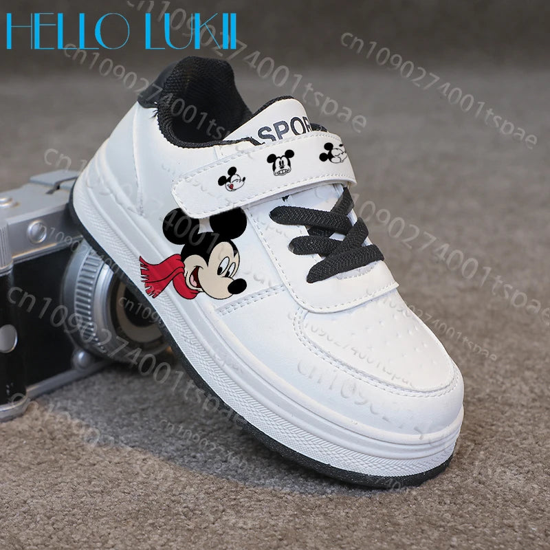 White sneaker with cartoon character design on a gray surface