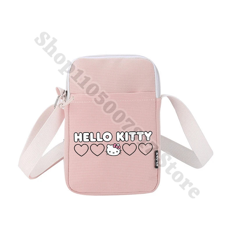 Pink crossbody bag with 'Hello Kitty' text and heart designs on a white background
