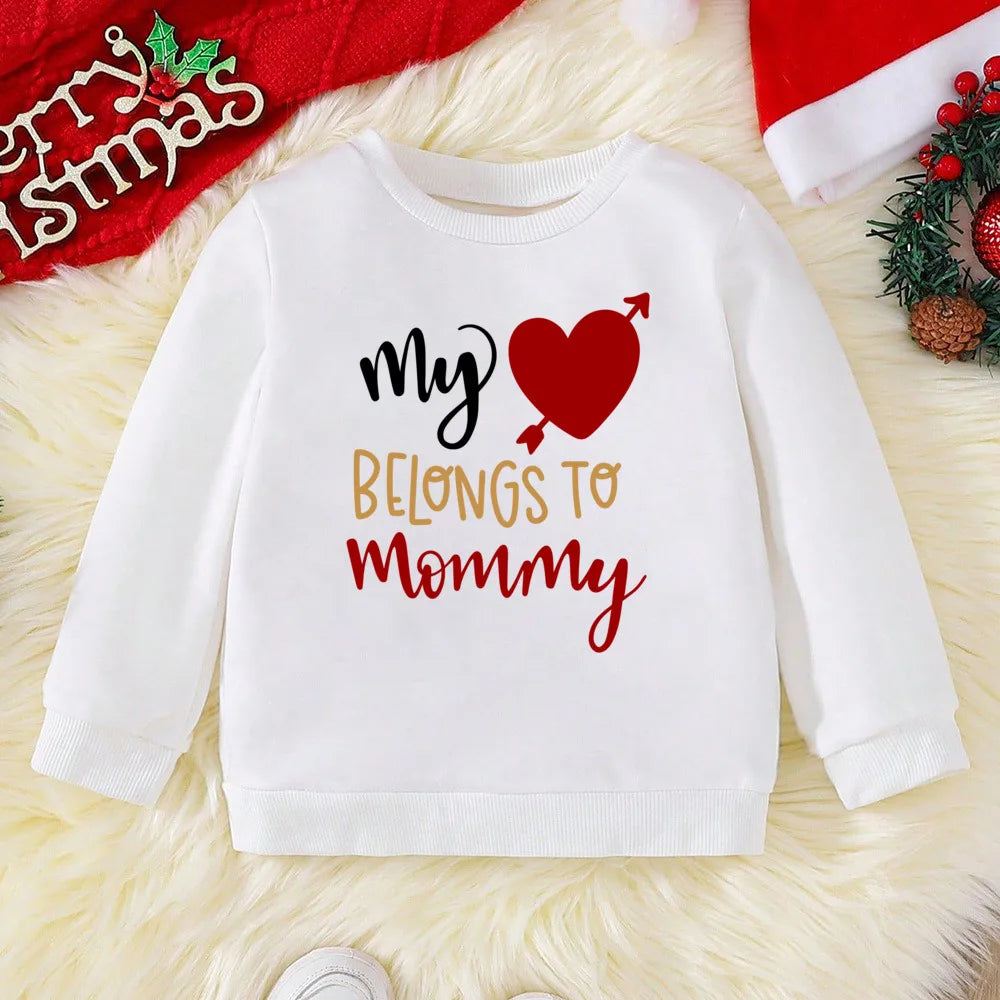 White sweatshirt with 'My Heart Belongs to Mommy' text on a festive background