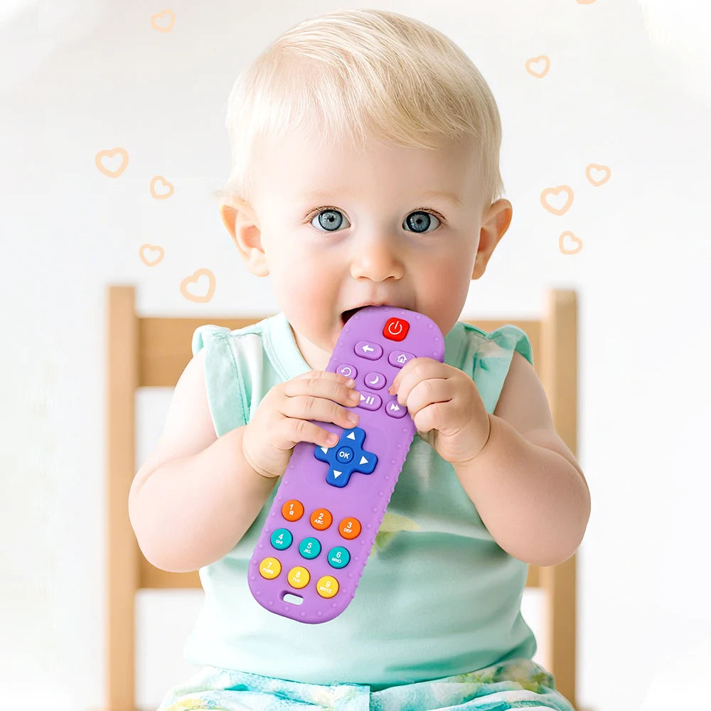Child holding a purple toy remote control with colorful buttons against a light background
