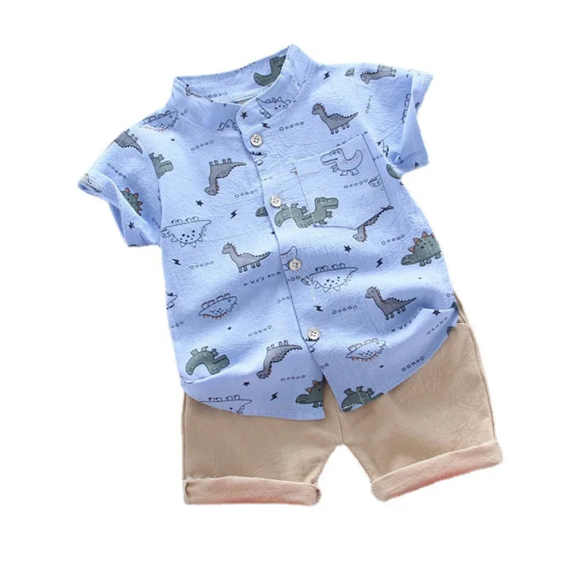 Children's outfit with blue shirt and beige shorts featuring dinosaur pattern on a white background