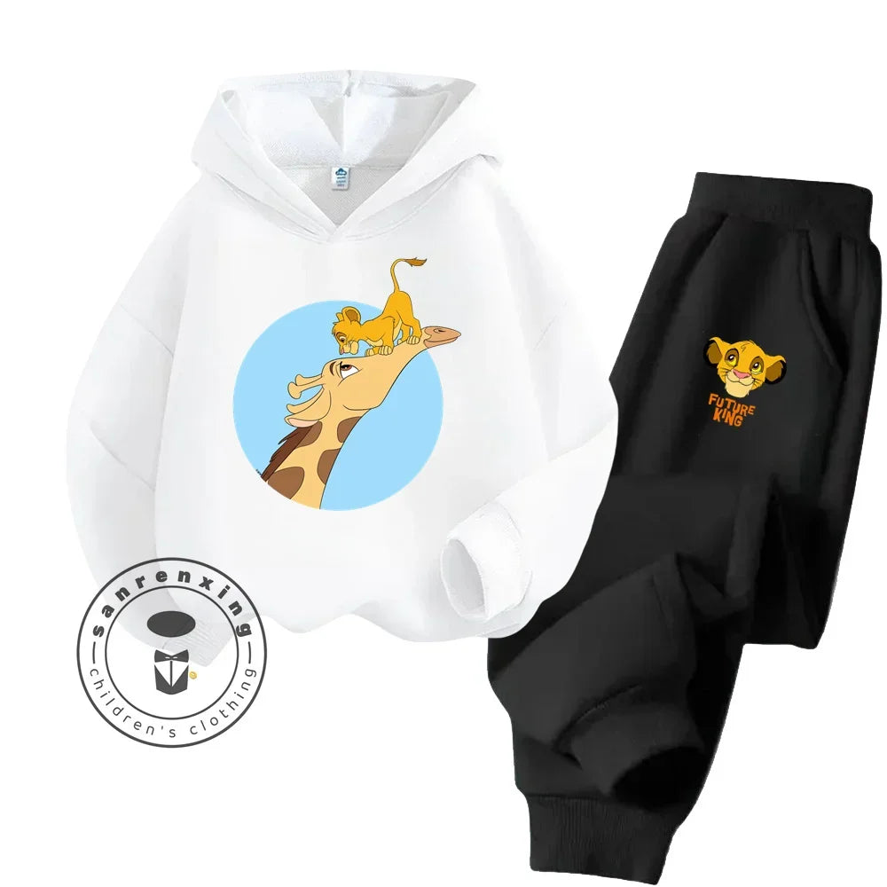 White hoodie with cartoon lion design and black pants with embroidered lion design on a white background.