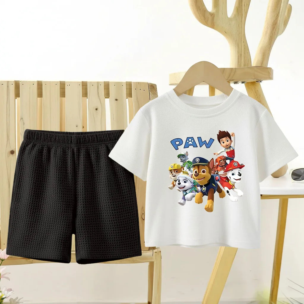 White t-shirt with cartoon characters and black shorts on a chair