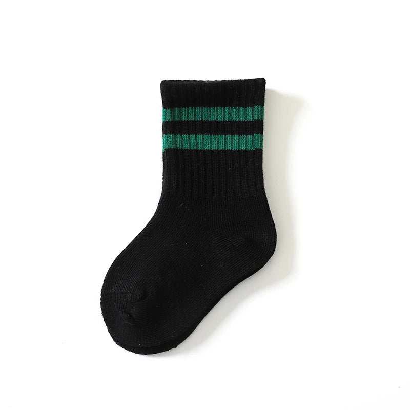 Black sock with green stripes on a white background