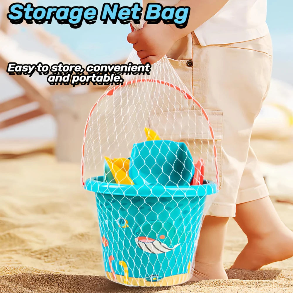 Blue bucket with toys inside a mesh storage bag on a sandy beach.