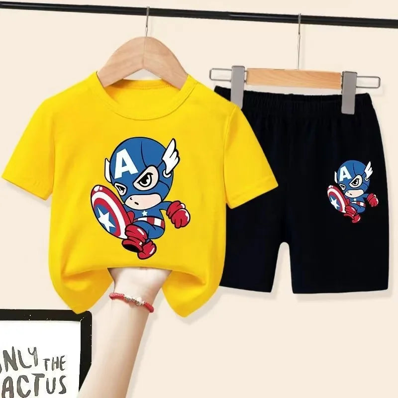 Yellow t-shirt and black shorts with Captain America design on hangers against a white background.