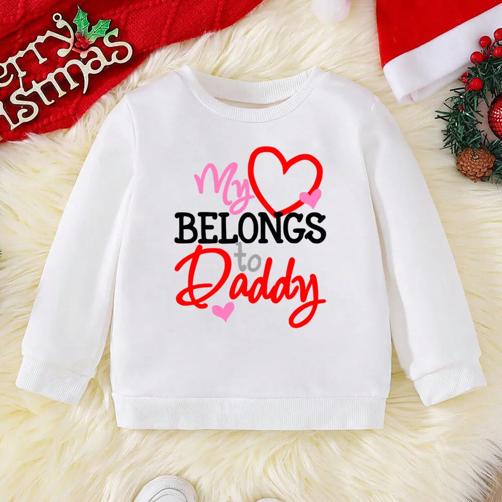 White sweatshirt with 'My heart belongs to Daddy' text on a festive background