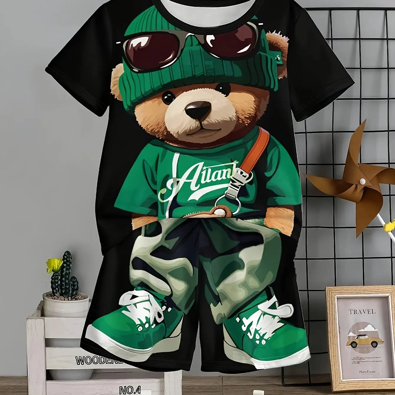 T-shirt with a bear graphic wearing sunglasses, green hat, and green 'Atlanta' shirt on a black background.