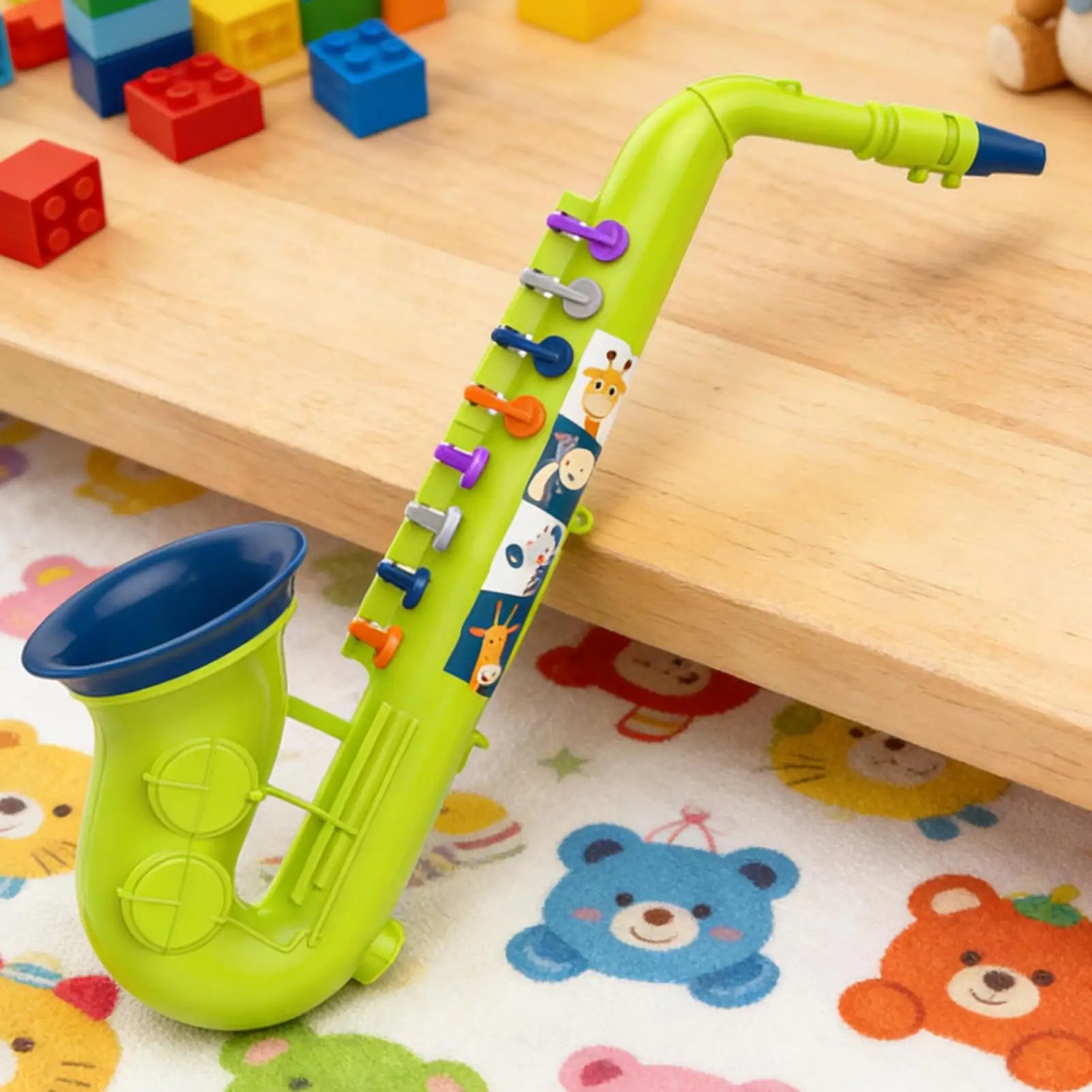 Toy saxophone with animal patterns on a wooden surface and colorful mat