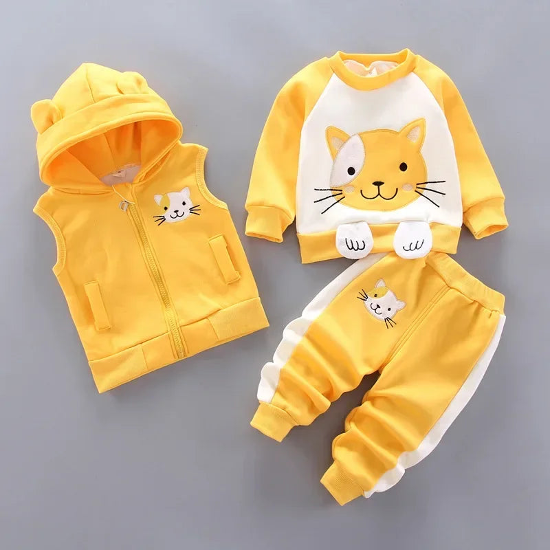 Yellow children's outfit with cat design on a gray background