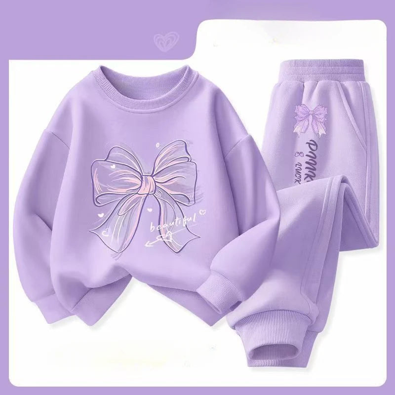 Purple children's sweatshirt and pants set with a bow design on a light purple background