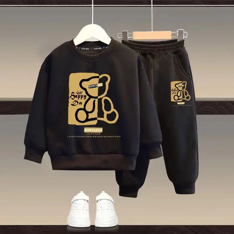 Black hoodie and pants set with gold bear logo on a neutral background