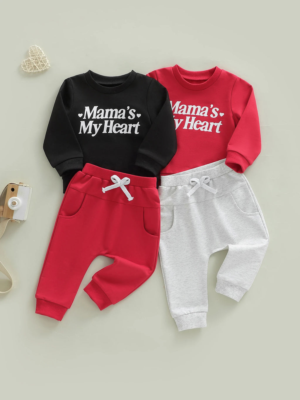 Two children's sweatshirt and pants sets with 'Mama's My Heart' text on a light gray background.
