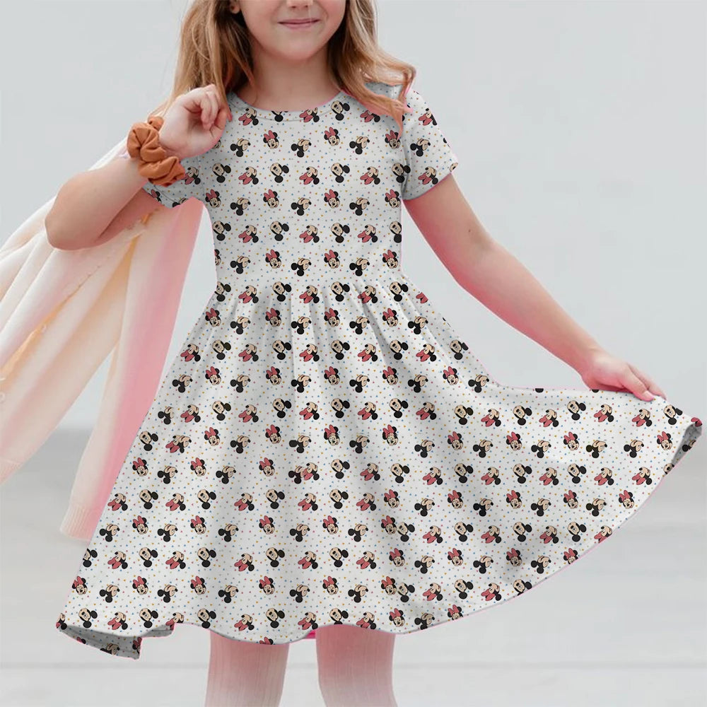Young girl wearing a floral dress against a plain background